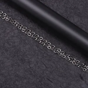 Detail of vintage punk double metal chains with O-link design in dark silver finish