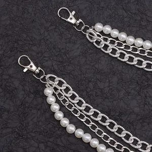 Close-up of double-layer silver metal chain with white pearls and lobster clasps