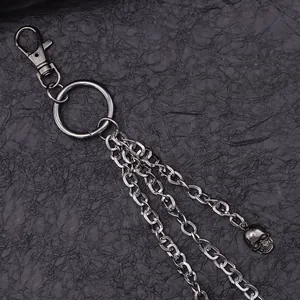 Detail of punk style double-layered metal trousers chain with a silver skull pendant