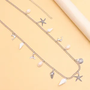 Detalle del cinturón de cadena plateado con colgantes marinos como estrellas de mar y conchas