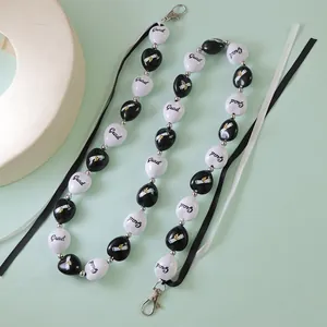 Cordon de remise de diplôme avec perles noires et blanches, pompons et fermoir homard