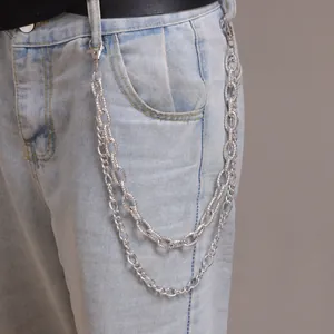 Detail of silver double-layered trousers chain with embossed texture and metal lobster clasps