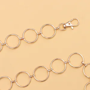 Detail of gold metal ring waist chain with lobster clasp for fashion dress styling