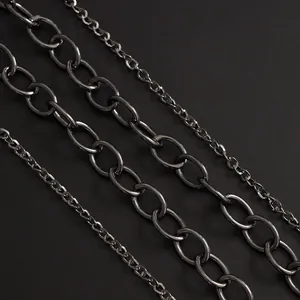 Macro shot of industrial gunmetal multi-layered metal chains with distressed leather cross