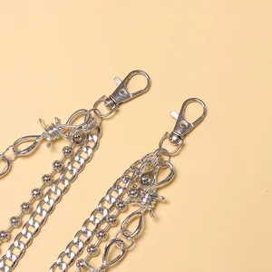Detail of silver multi-layer punk hip-hop waist chain with barbed wire links and lobster clasps