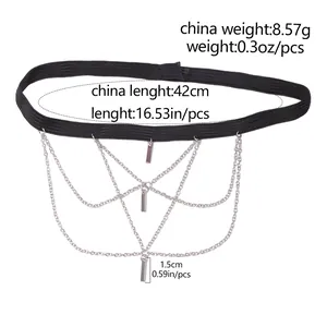Detailed view of layered silver-tone leg chain with black elastic band and rectangular tags
