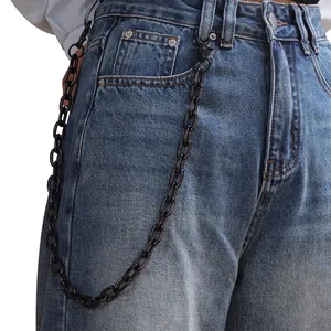 Close-up of matte black metal hip-hop pants chain accessory styled on blue denim jeans