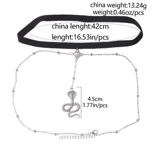 Detail of elastic leg chain with silver snake pendant and decorative metal beads