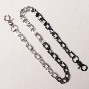 Detail of hip-hop waist chain with alternating silver and black metal lobster clasps