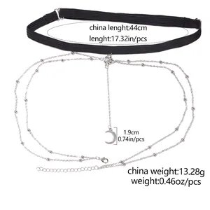 Detailed view of layered silver leg chain with crescent moon pendant and elastic band