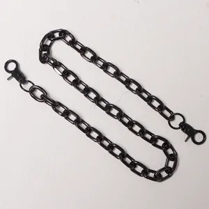 Detailed view of glossy black metal pants chain with 360-degree lobster clasps