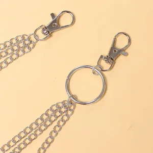 Detail of triple-layer silver metal pants chain with heart wing charms and lobster clasps