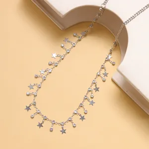 Silver body chain with star pendants and rhinestones on geometric decor props