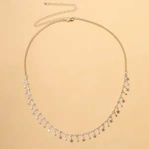 Detail of gold star body chain featuring rhinestone tassels and adjustable lobster clasp