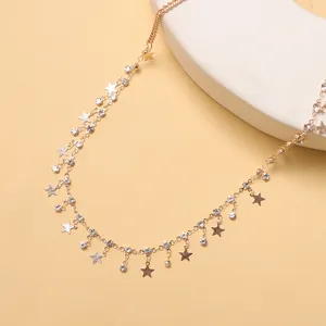 Golden star tassel body chain with rhinestones on a warm display stand for women