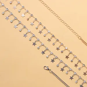 Macro shot of silver waist chain with pentagram pendants and sparkling rhinestones