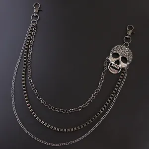 Detail of punk multi-layer metal waist chain with spiked skull pendant and snap hooks