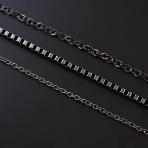 Detailed view of three punk multilayered waist chains in gunmetal finish for men