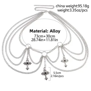 Macro detail of multi-layer silver waist chain featuring gothic crosses with black stones