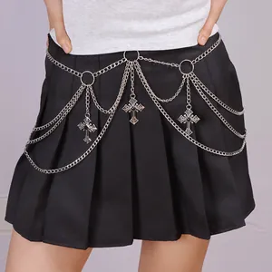 Detail of silver multi-layer metal waist chain with cross pendants on a black pleated skirt