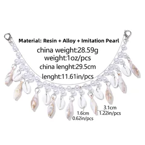 Detailed view of bohemian bag chain featuring resin shells and white imitation pearls