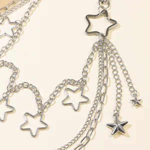 Close-up of layered silver star waist chain with hollow five-pointed star charms