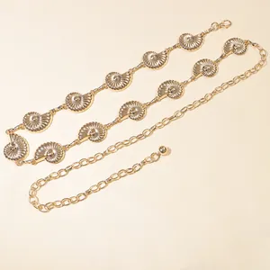 Detailed view of golden metal shell-shaped waist chain with adjustable extender links