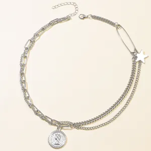 Dettaglio collana argento asimmetrica con stella, spilla da balia e ciondolo a moneta ritratto