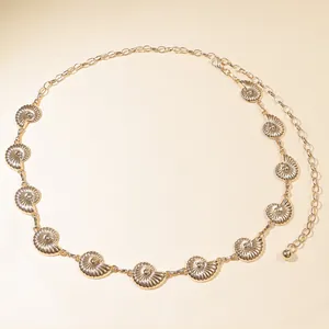 Detailed close-up of gold metal waist chain featuring seashell charms and lobster clasp