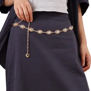 Detail of sunflower waist chain featuring crystal inlays on gold metal chain over a dress