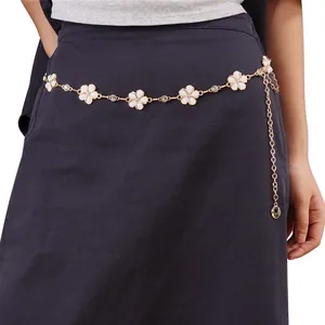 Detail of adjustable gold metal waist chain with white sunflower motifs and rhinestones