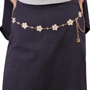 Detailed close-up of golden sunflower waist chain with white enamel petals and shiny rhinestones