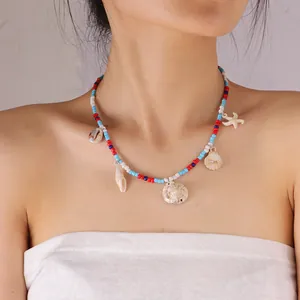 Detail of bohemian beaded necklace with shell and starfish pendants on a model