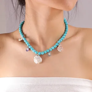 Bohemian blue beaded necklace with white spiral shell and scallop ocean charms