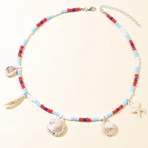 Detail of colorful beaded necklace with seashells and starfish charms on a beige background