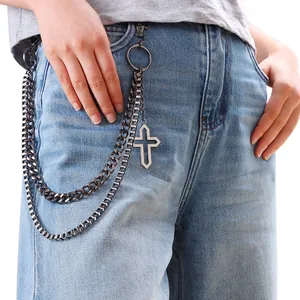 Detail of gunmetal double-layer street pants chain with hollow cross pendant on jeans