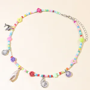 Detailed shot of bohemian colorful beaded necklace with sea shells and dolphin pendant