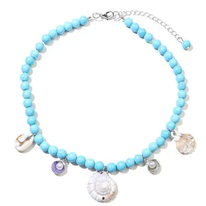 Detail view of Bohemian turquoise beaded necklace with assorted sea shells and pearls
