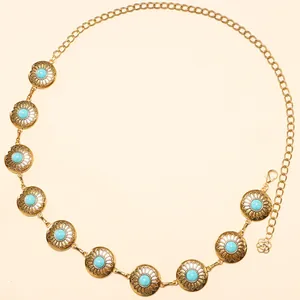 Detailed view of bohemian gold waist chain with turquoise inlay and sunburst engravings