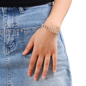Close-up of sparkling double-layer rhinestone bracelet worn on wrist with gold finish