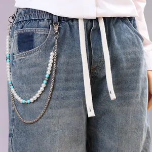 Detailansicht der doppellagigen Hüftkette mit Türkisperlen und Perlen auf blauer Jeans