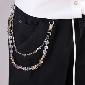 Close-up of punk style silver metal pants chain with clear crystal beads and thorn charms