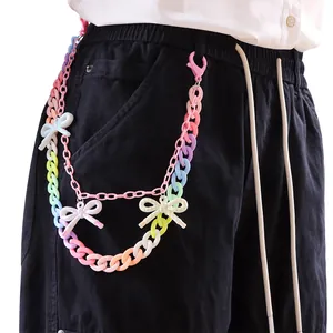 Detail of colorful acrylic layered pants chain with Y2K macaron bow charms on white clothing