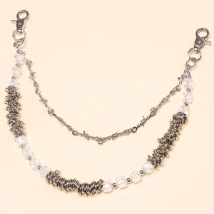 Macro shot of silver punk double-layer pants chain with barbed wire and crystal beads