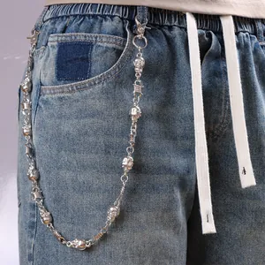 Silver skull and barbed wire metal pants chain on blue jeans for punk style