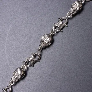 Macro shot of punk style trousers chain with skull and barbed wire metal link detail