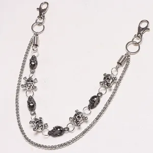 Dual-layer punk metal waist chain with skulls and lobster clasps on white background