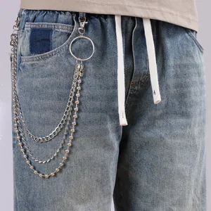 Three-layer silver metal pants chain with beads and lobster clasp on light wash denim
