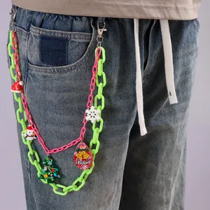 Close-up of double-layer acrylic pants chain with neon green links and Christmas charms