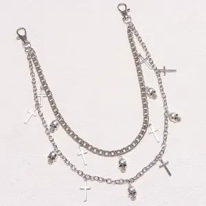 Close-up of retro punk layered metal trouser chain with skull and cross charms